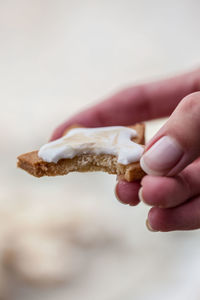 Cropped hand of person holding cookie