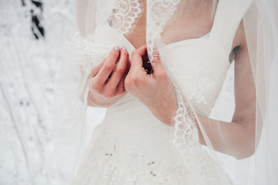 Midsection of mother and daughter holding hands