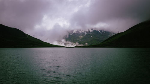 Scenic view of lake and mountains against sky