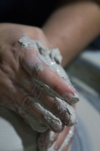 Cropped hands working on pottery wheel