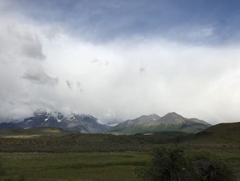 Scenic view of mountains against cloudy sky