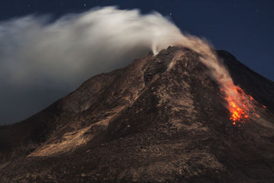 Scenic view of mountains against sky at night