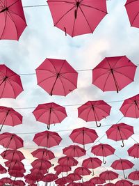 Low angle view of umbrellas against sky