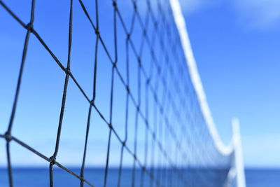 Close-up of fence against blue sky