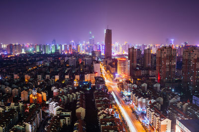 Aerial view of illuminated buildings in city at night