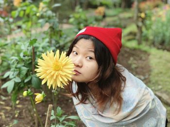 Portrait of smiling girl with yellow flower