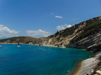 Scenic view of sea and mountains against sky