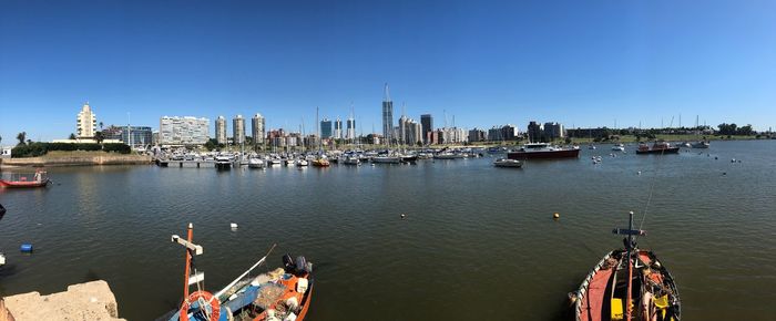 Boats in river with city in background