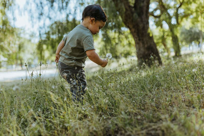 Full length of boy standing on field