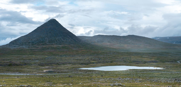 View of volcanic mountain against cloudy sky