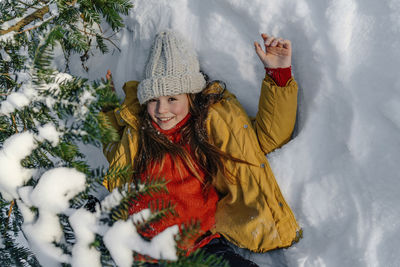 Portrait of smiling woman in snow