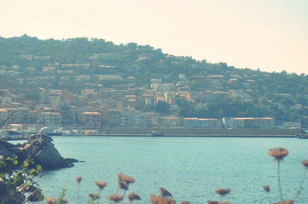 water, sea, tranquil scene, tranquility, waterfront, rock, calm, scenics, day, blue, mountain, nature, rock formation, ocean, cliff, non-urban scene, rocky, beauty in nature, no people, in front of, distant