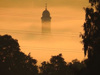 Silhouette of power lines at sunset