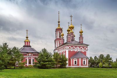 Church by building against sky