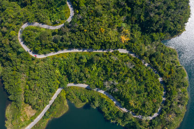 Aerial view road along mea suai dam connecting the city and green forest at chiang rai thailand