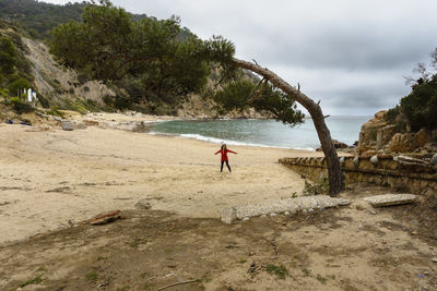 Man on beach against sky