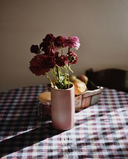 Close-up of flowers in vase on table at home