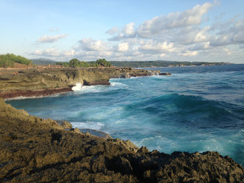 Scenic view of sea against cloudy sky