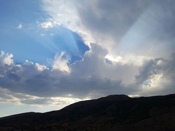 Scenic view of mountains against cloudy sky