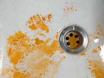 Close-up of yellow paint stain on sink