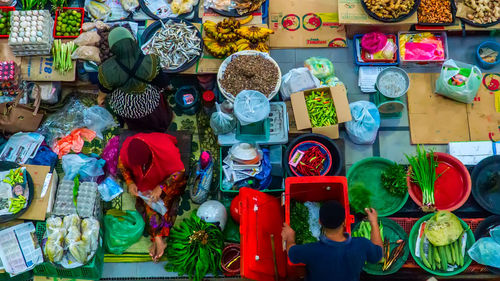 High angle view of vendors selling food at market stall