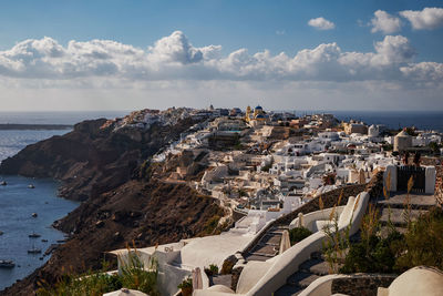 High angle view of townscape by sea against sky
