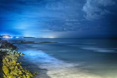 Scenic view of sea against cloudy sky