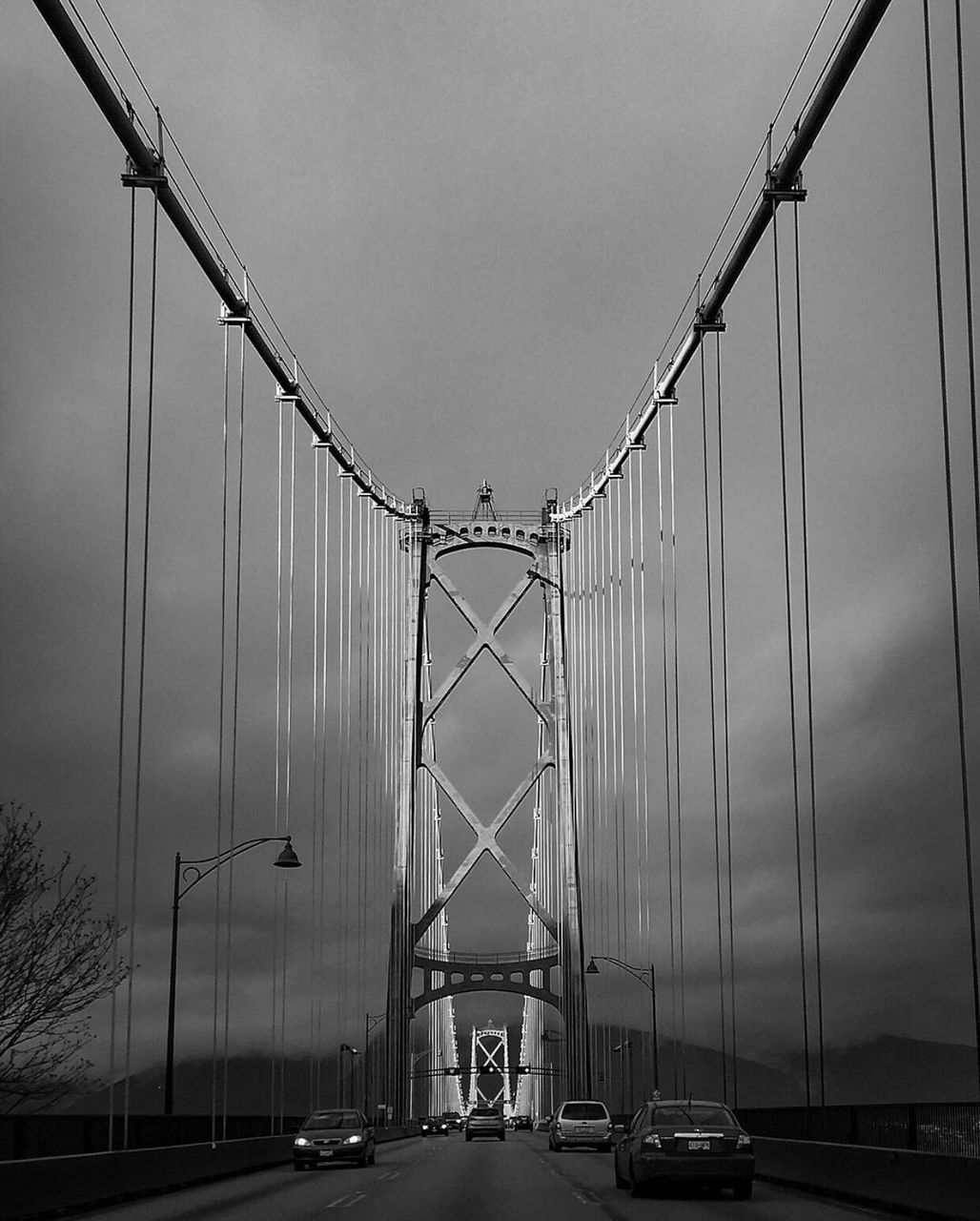 transportation, connection, car, mode of transport, land vehicle, sky, engineering, suspension bridge, bridge - man made structure, built structure, road, low angle view, the way forward, electricity pylon, architecture, diminishing perspective, outdoors, crane - construction machinery, street light, clear sky