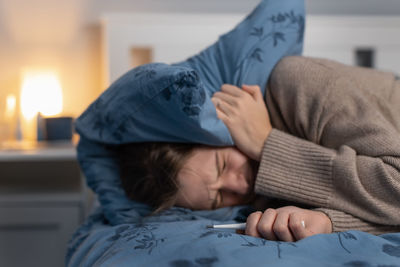 Young caucasian woman suffering from severe headache or migraine. female suffers from cold and flu