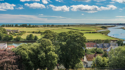 Scenic view of trees and buildings against sky