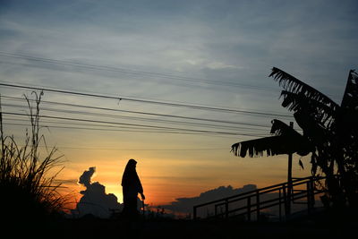 Silhouette people against sky during sunset