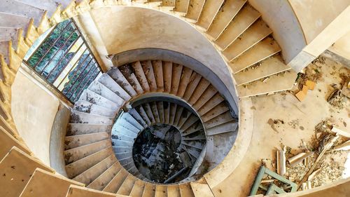 High angle view of spiral staircase in abandoned building