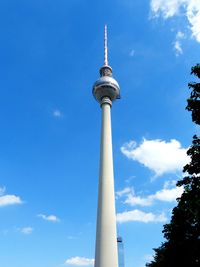 Low angle view of tower against blue sky