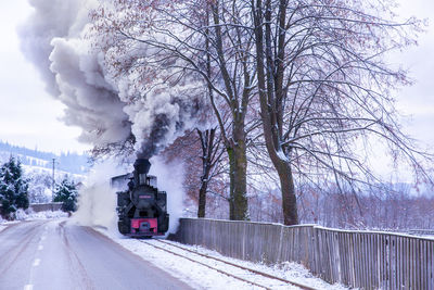 Steam train on a snow covered railtrack