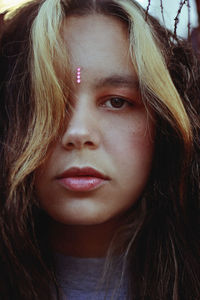 Close-up portrait of young woman in brown hair