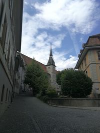 Street amidst buildings against sky in city