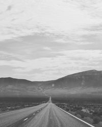 Road passing through landscape against sky