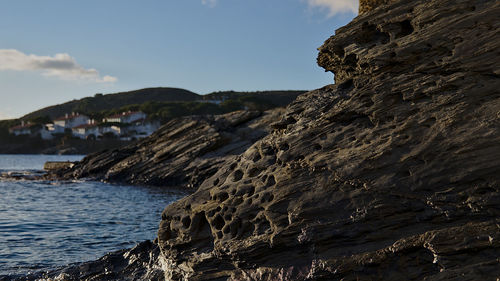 Scenic view of sea and mountains against sky