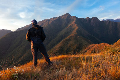 Man standing on mountain against sky