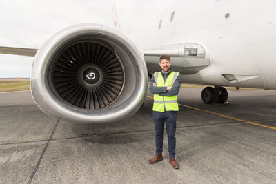 Confident mechanic near plane turbine