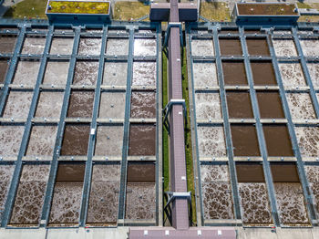 High angle view of walkway over water at factory during sunny day