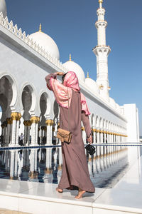 Full length of man standing in temple against building