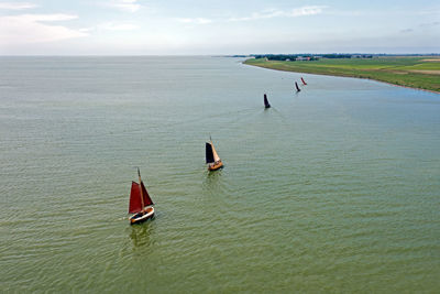 Aerial from traditional dutch wooden boats at the ijsselmeer in friesland the netherlands