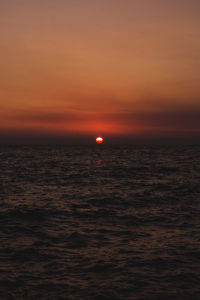 Scenic view of sea against romantic sky at sunset