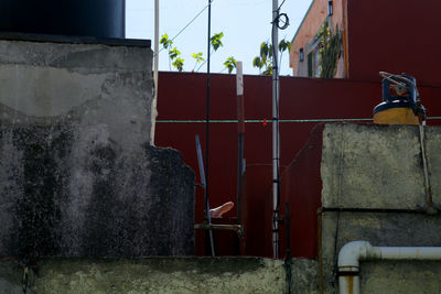 Metal structure against wall in yard