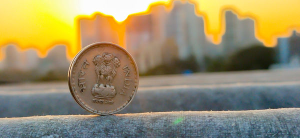 Close-up of coins on wood