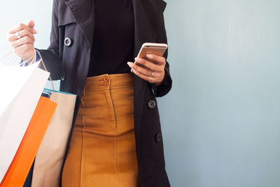 Midsection of man using mobile phone