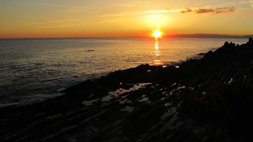 Scenic view of sea at sunset