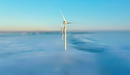 Wind turbines against blue sky