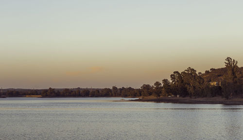 Scenic view of sea against clear sky during sunset